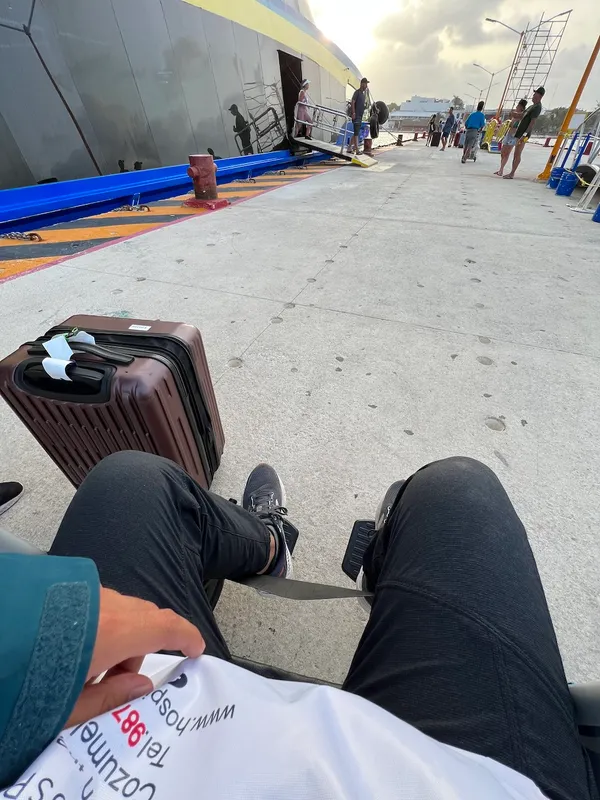 Victor in a wheelchair getting off a ferry boat