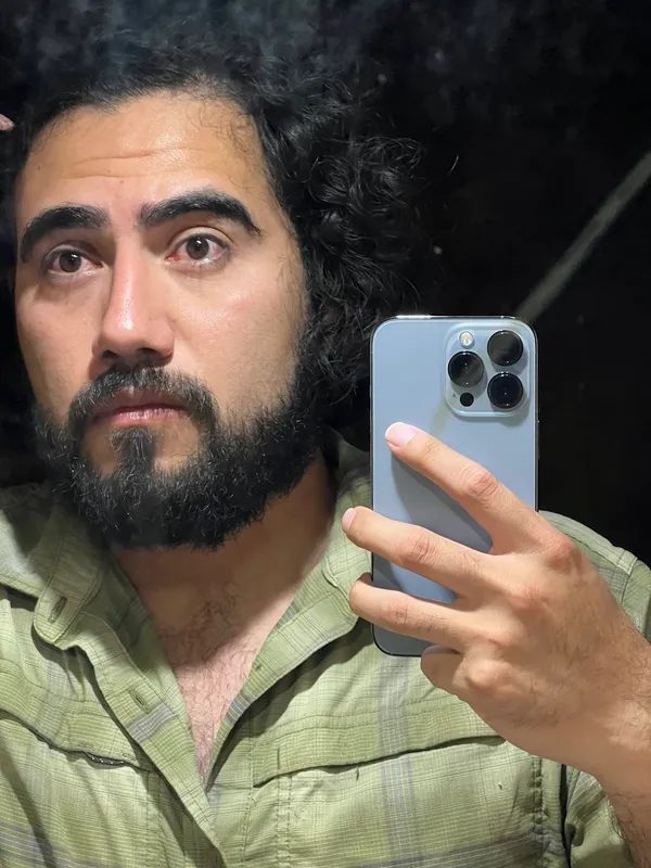 Mirror selfie of Victor with bloodshot red eyes